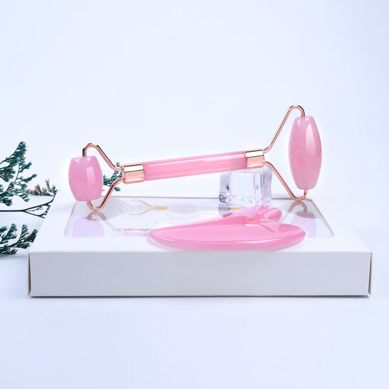 Pink Resin Face massager roller set with Guasha, for anti aging, and skin rejuvenation.