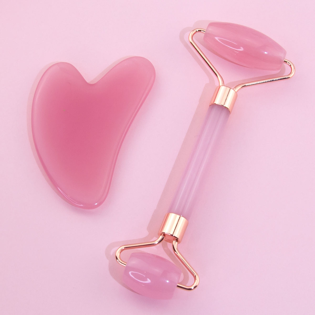 Pink Resin Face massager roller set with Guasha, for anti aging, and skin rejuvenation.